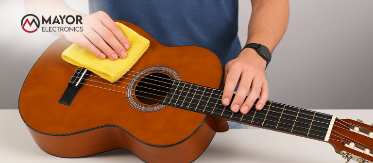 Persona limpiando las cuerdas de una guitarra con un paño de microfibra