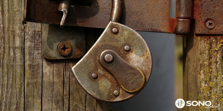Un cadenas ouvert sur une porte ancienne
