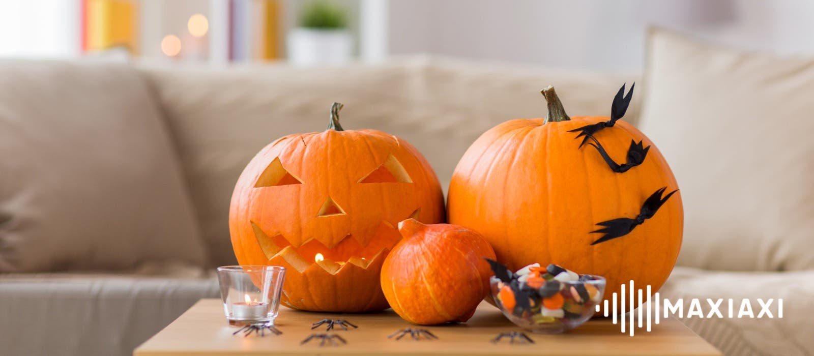 vrolijke halloween pompoenen op een tafel met nep spinnen en halloweensnoep